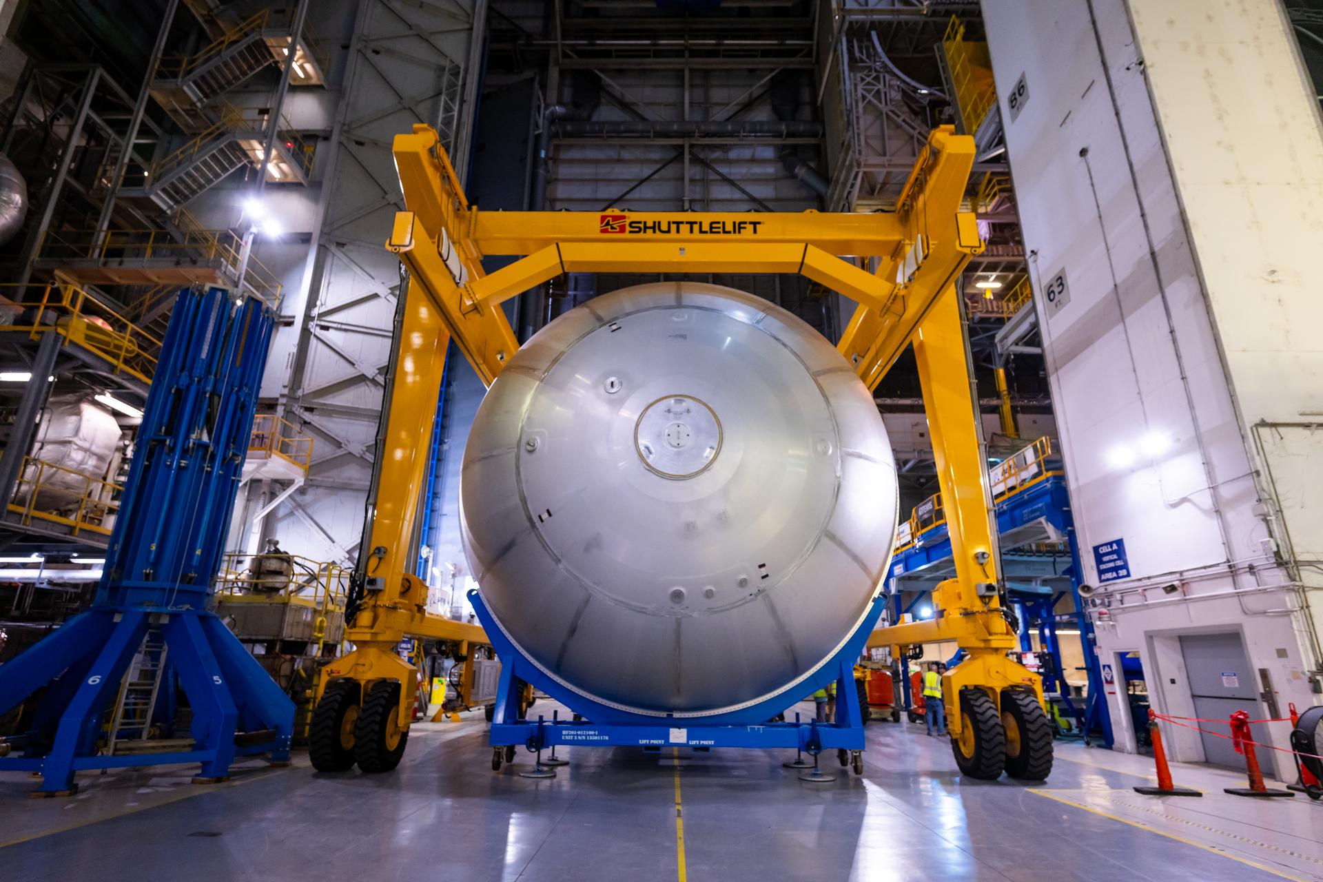 Teams at NASA’s Michoud Assembly Facility in New Orleans move a liquid oxygen tank from the main rocket factory into the adjacent vertical assembly building. The liquid oxygen tank, which will form part of the SLS (Space Launch System) rocket for NASA’s Artemis IV mission to the Moon, is rotated from a horizontal to a vertical configuration and loaded into the high bay’s hydrostatic proof testing cell. This non-destructive evaluation method tests the structural integrity of the tank’s welds by filling the tank with water, simulating the propellant used during launch. The propellant tank will hold more than 196,000 gallons of super-cooled liquid oxygen at launch and is one of five major elements that make up the 212-foot-tall SLS rocket stage. The core stage, along with its four RS-25 engines at its base, produces more than two million pounds of thrust to help launch NASA’s Orion spacecraft, astronauts, and supplies beyond Earth’s orbit and to the lunar surface for Artemis.